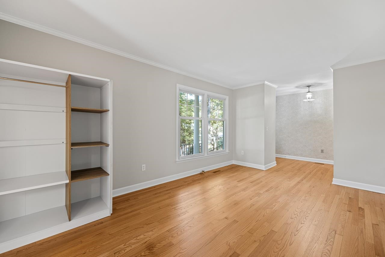 3517 Brecknock Street Durham, NC 27705 - Photo 5 of 38 a view of an empty room with a window and wooden floor