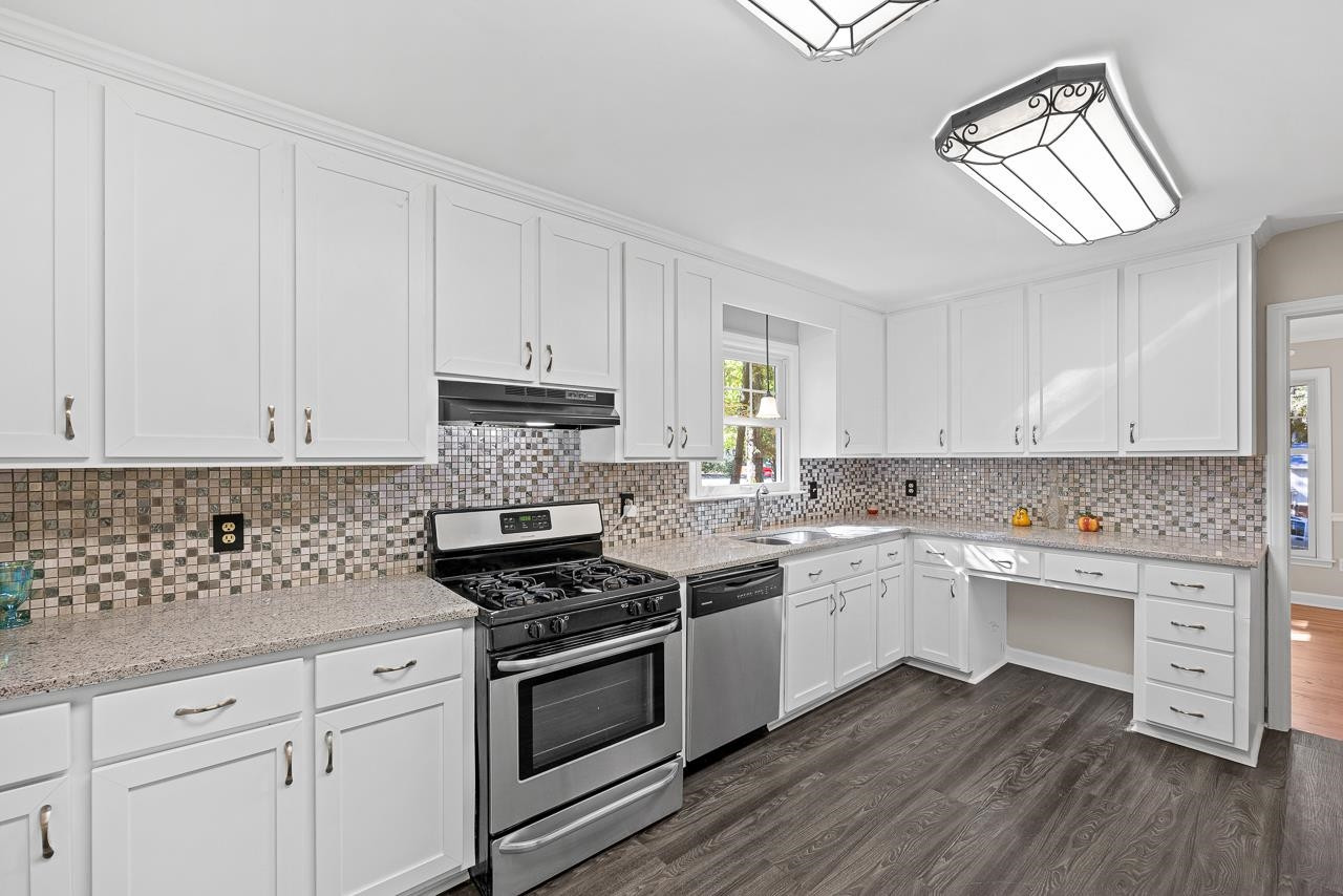3517 Brecknock Street Durham, NC 27705 - Photo 8 of 38 a kitchen with cabinets appliances a sink and a window