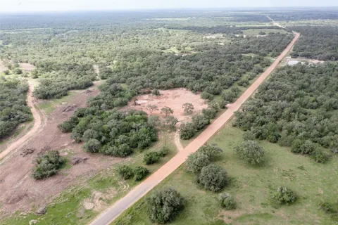 an aerial view of mountain with yard and green space