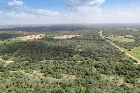 an aerial view of residential building and trees around
