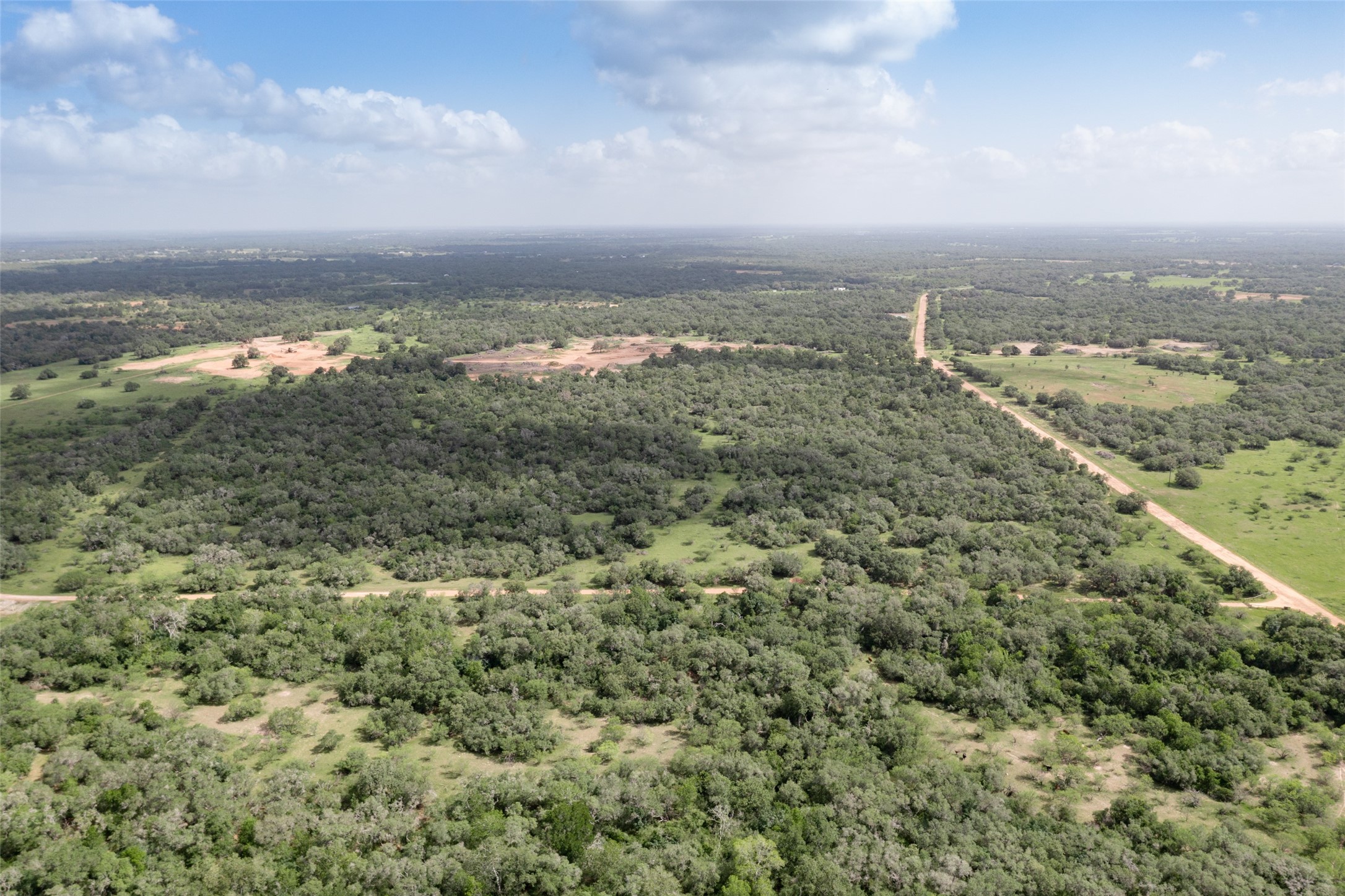 24.68-acres Cattle Guard Road Cuero, TX 77954 - Photo 19 of 49 an aerial view of residential building and trees around
