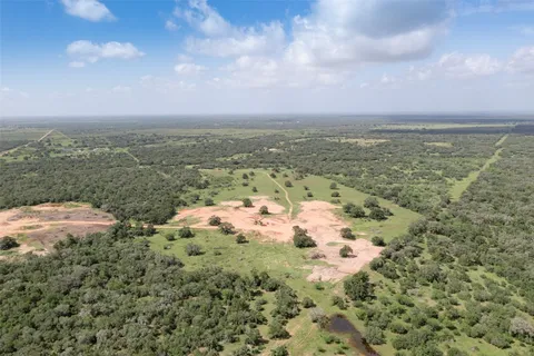 a view of a green field with lots of trees