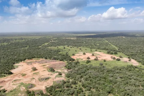 a view of a big yard with lots of bushes