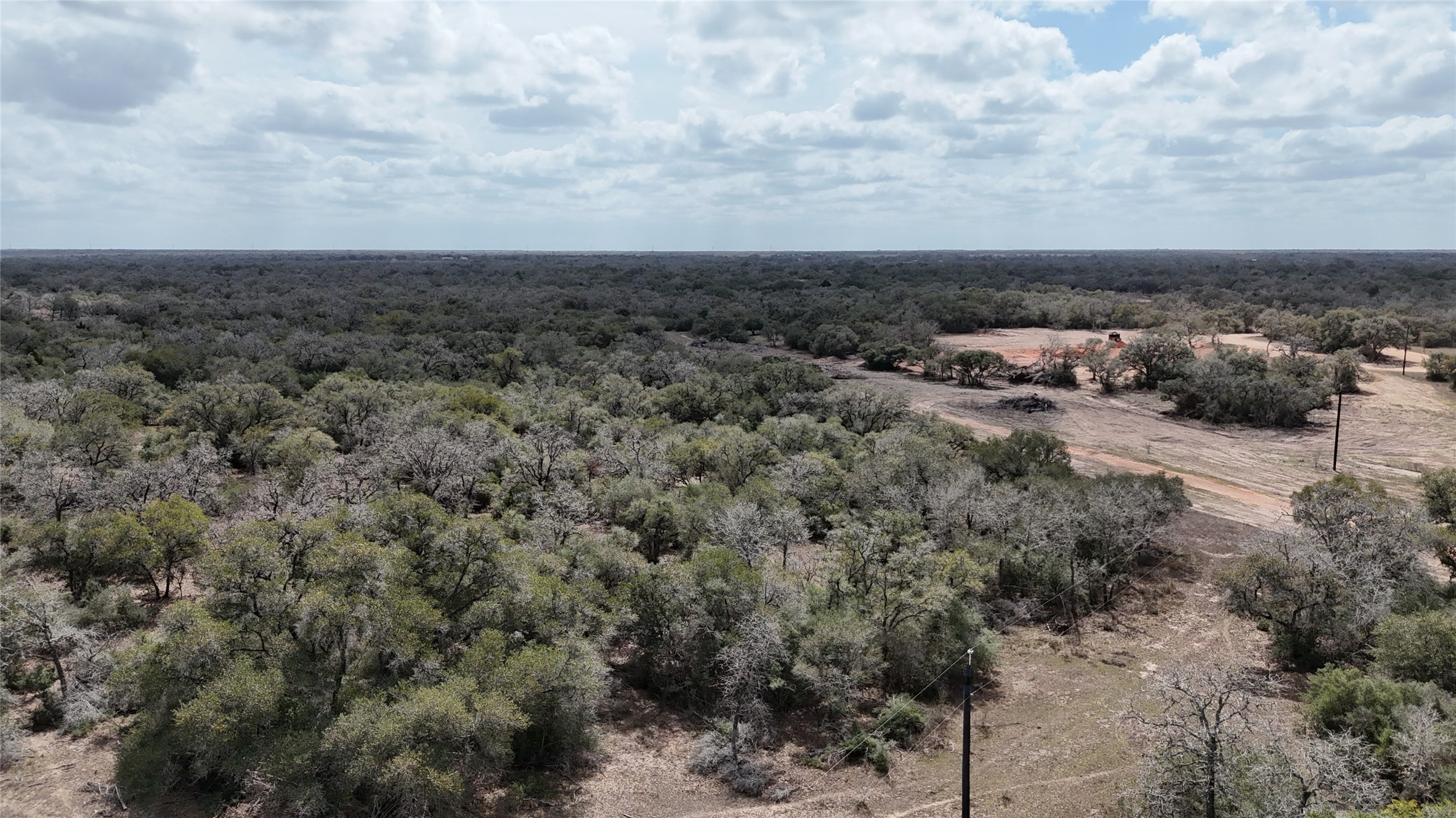 24.68-acres Cattle Guard Road Cuero, TX 77954 - Photo 47 of 49 an aerial view of house with yard and mountain view in back