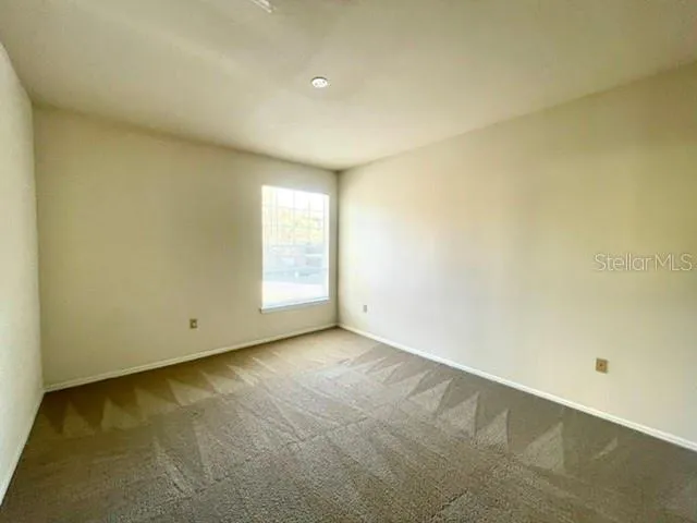 an empty room with a empty space and a window