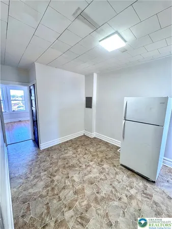 a view of a room with a refrigerator and microwave