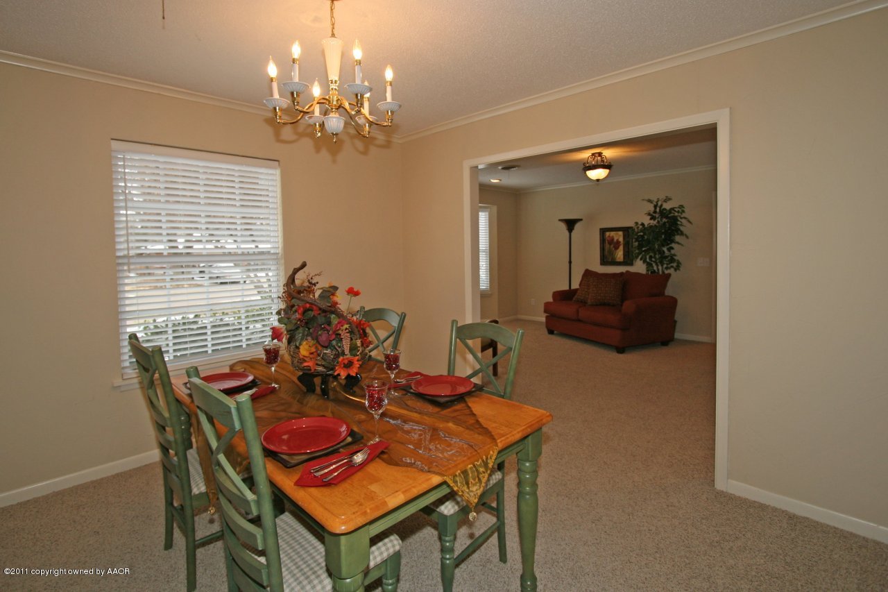 6111 Jameson Road Amarillo, TX 79106 - Photo 5 of 15 a view of a dining room with furniture and chandelier