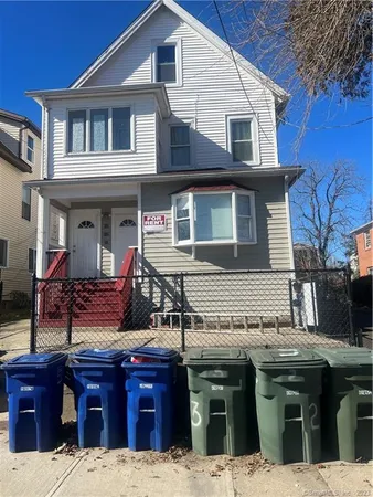 a view of a house with wooden fence