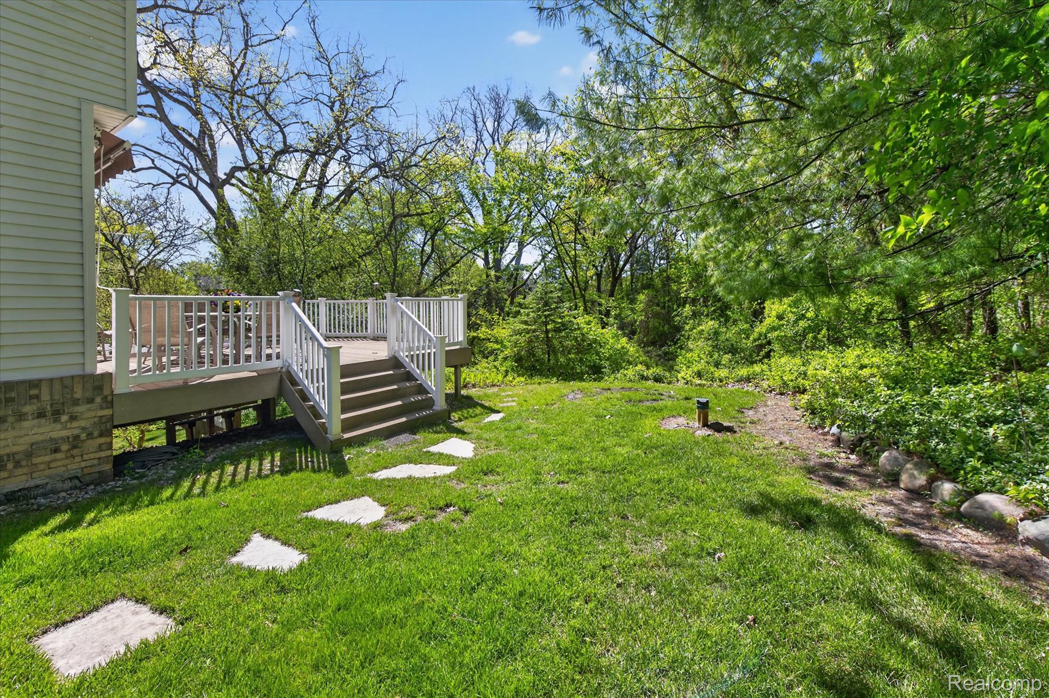 7798 Lee Road Brighton, MI 48116 - Photo 43 of 49 View of green lawn with a deck