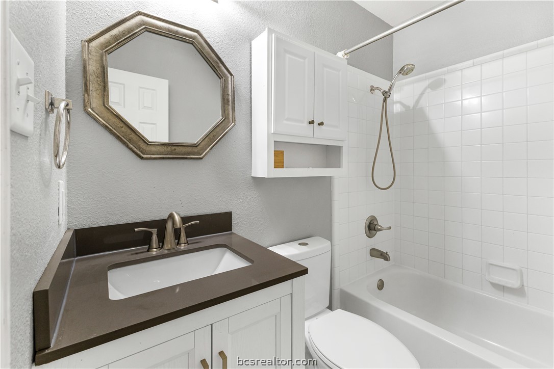 3709 Springfield Drive College Station, TX 77845 - Photo 19 of 23 a bathroom with a sink a toilet and a mirror