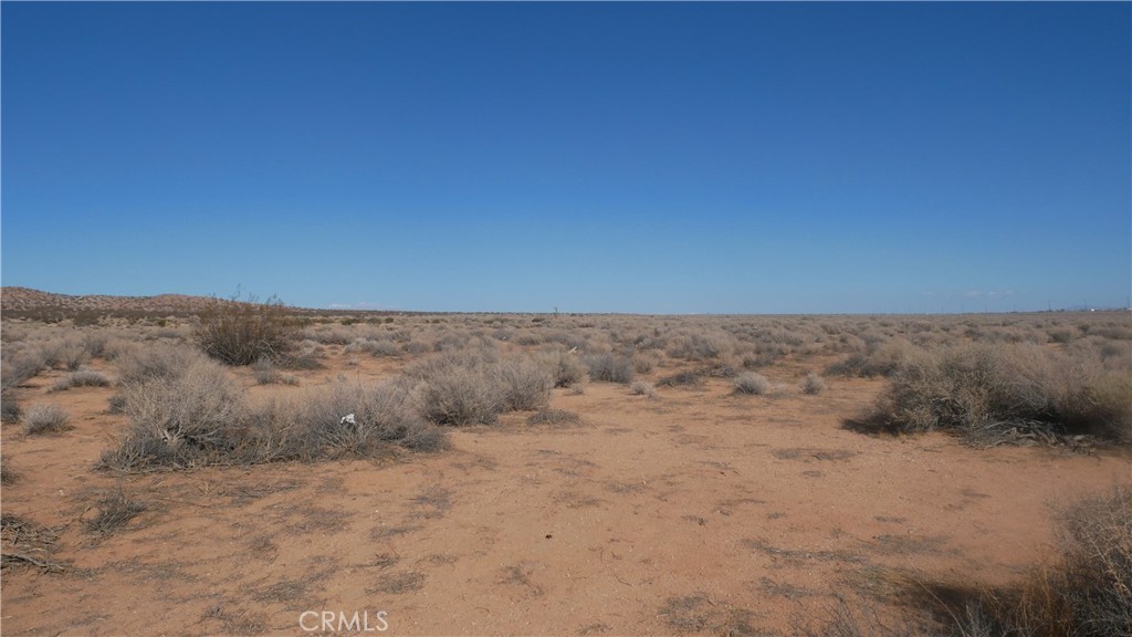 0 Castle Road Boron, CA 93516 - Photo 13 of 20 a view of a dry yard with mountains in the background