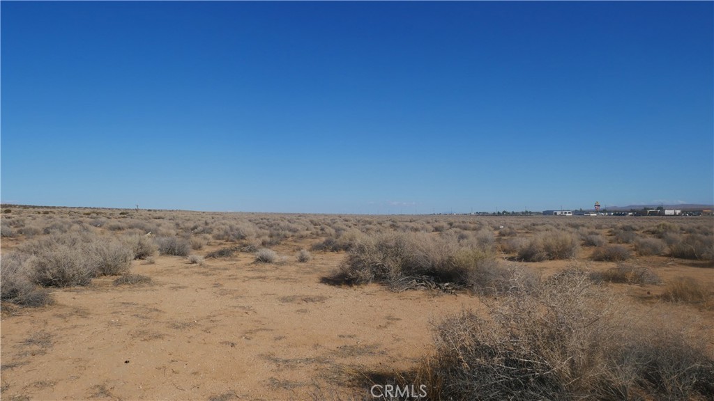 0 Castle Road Boron, CA 93516 - Photo 14 of 20 a view of a dry field with trees in the background