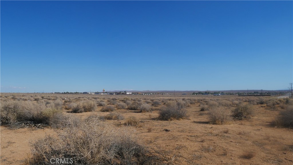 0 Castle Road Boron, CA 93516 - Photo 15 of 20 a view of a dry yard with wooden fence