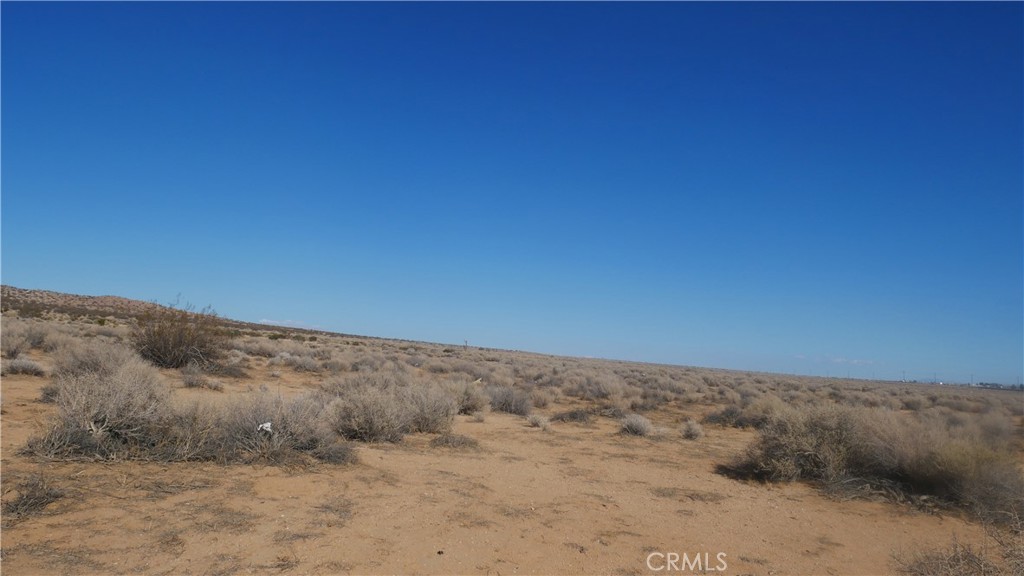 0 Castle Road Boron, CA 93516 - Photo 9 of 20 a view of a dry field with trees in background