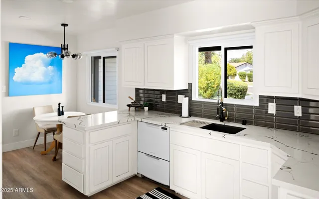 a kitchen with a sink stove and cabinets