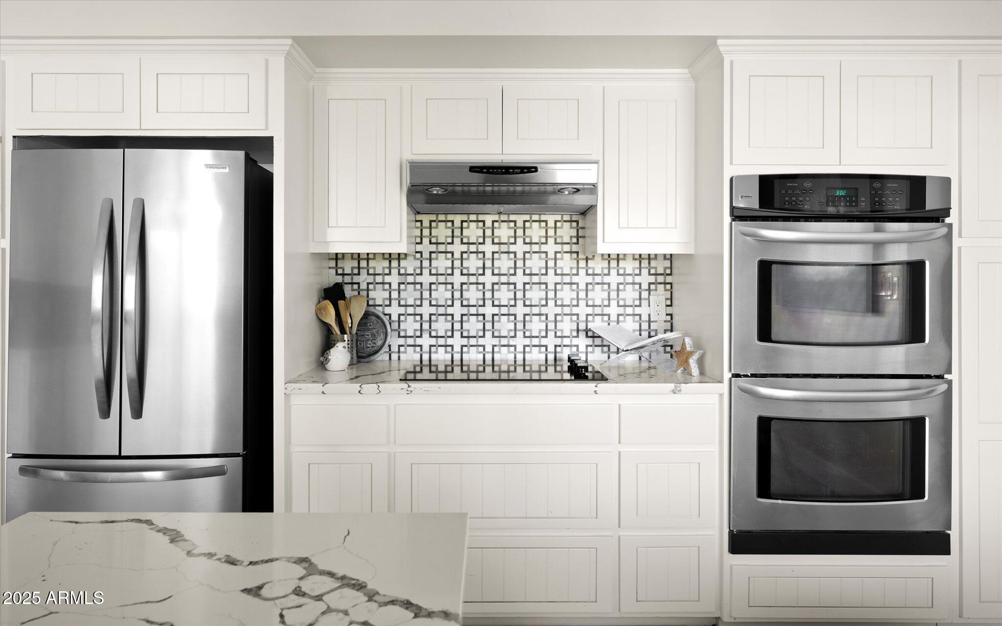 7508 North 13th Avenue Phoenix, AZ 85021 - Photo 18 of 36 a kitchen with granite countertop white cabinets and stainless steel appliances