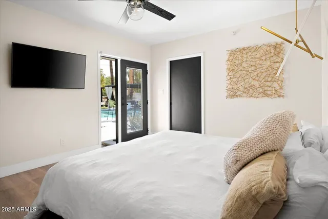 a bedroom with a large bed and a flat screen tv