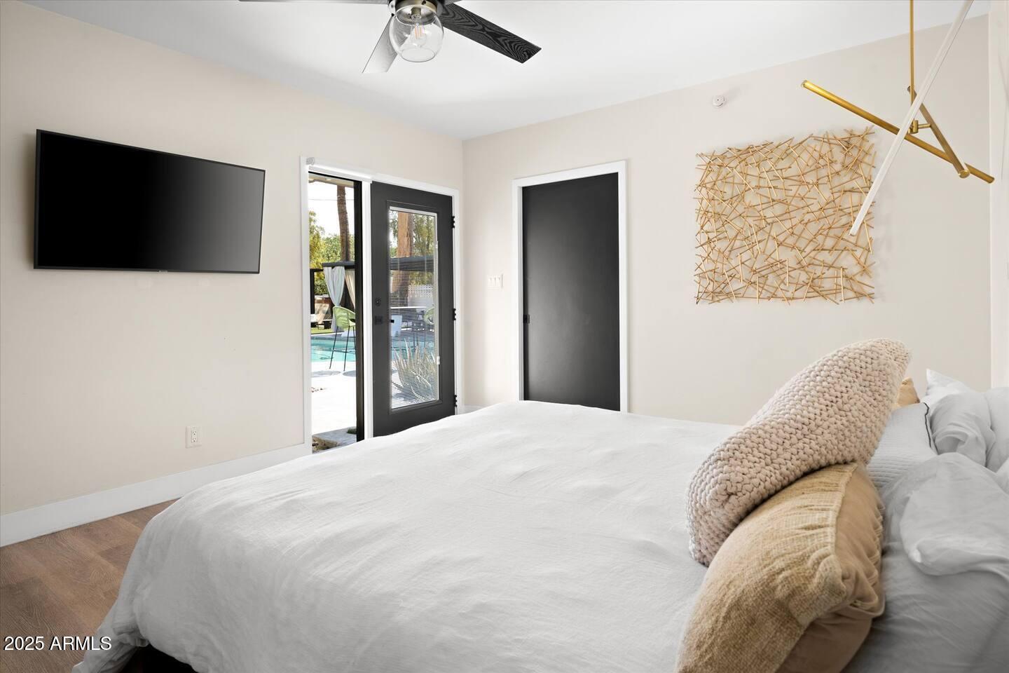 7508 North 13th Avenue Phoenix, AZ 85021 - Photo 20 of 36 a bedroom with a large bed and a flat screen tv