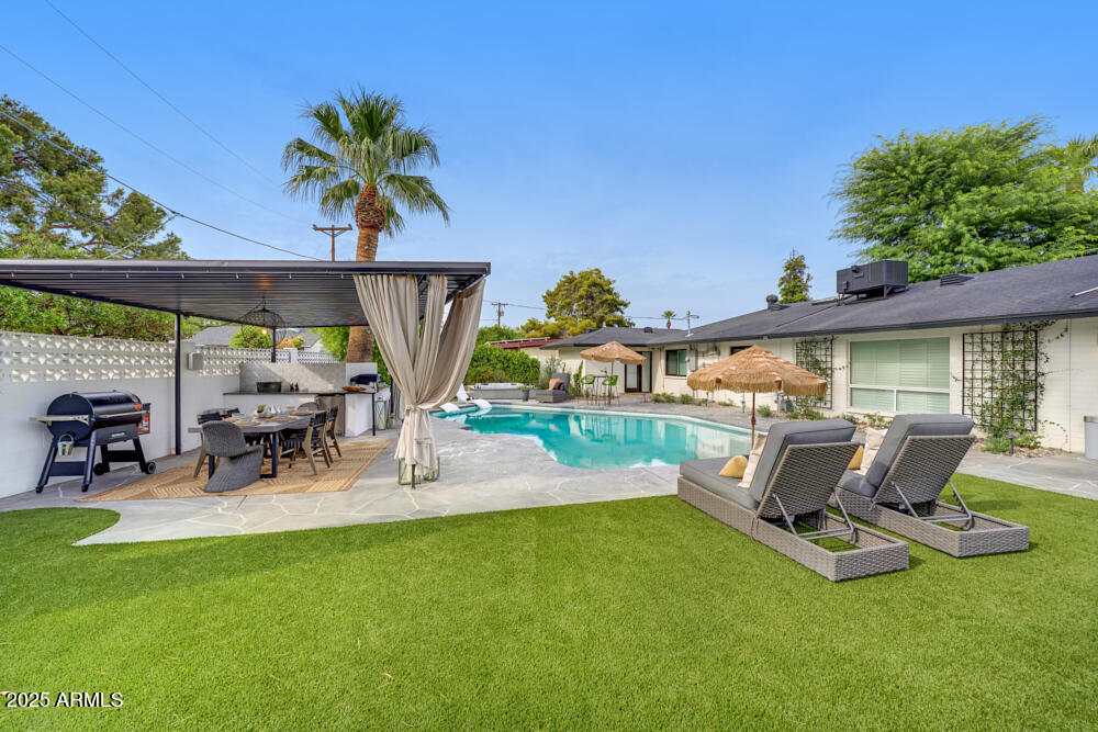 7508 North 13th Avenue Phoenix, AZ 85021 - Photo 2 of 36 a view of a patio with table and chairs potted plants with wooden fence
