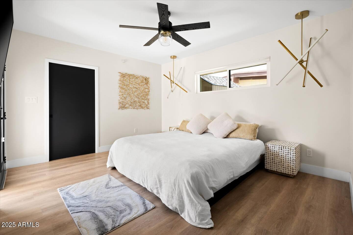 7508 North 13th Avenue Phoenix, AZ 85021 - Photo 21 of 36 a bedroom with bed and wooden floor