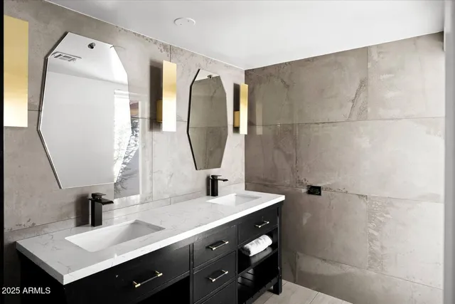 a bathroom with a sink vanity and a mirror