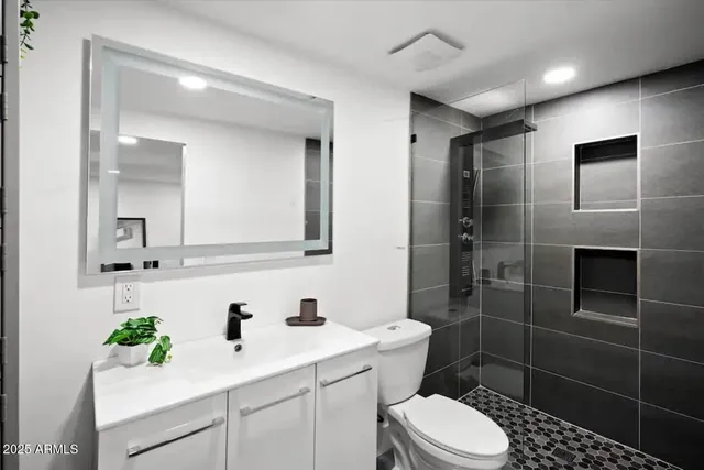 a bathroom with a sink toilet and shower