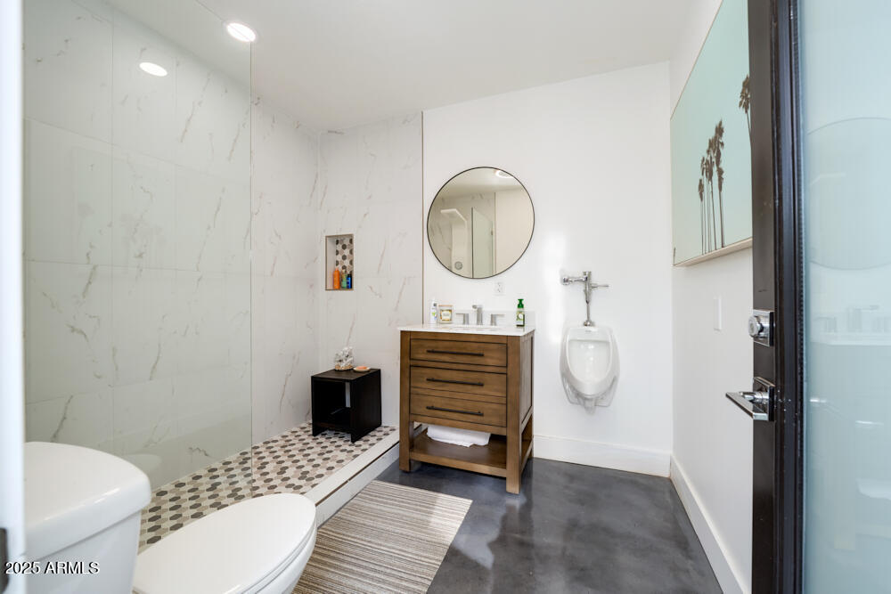 7508 North 13th Avenue Phoenix, AZ 85021 - Photo 8 of 36 a bathroom with a toilet a sink and mirror