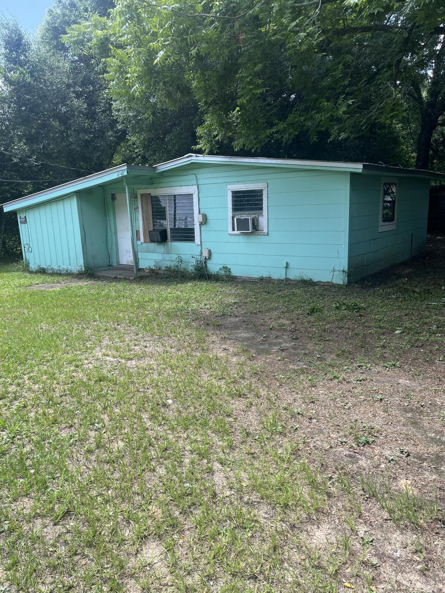 401-409 Brock Avenue Crestview, FL 32539 - Photo 2 of 10 a backyard of a house with lots of green space