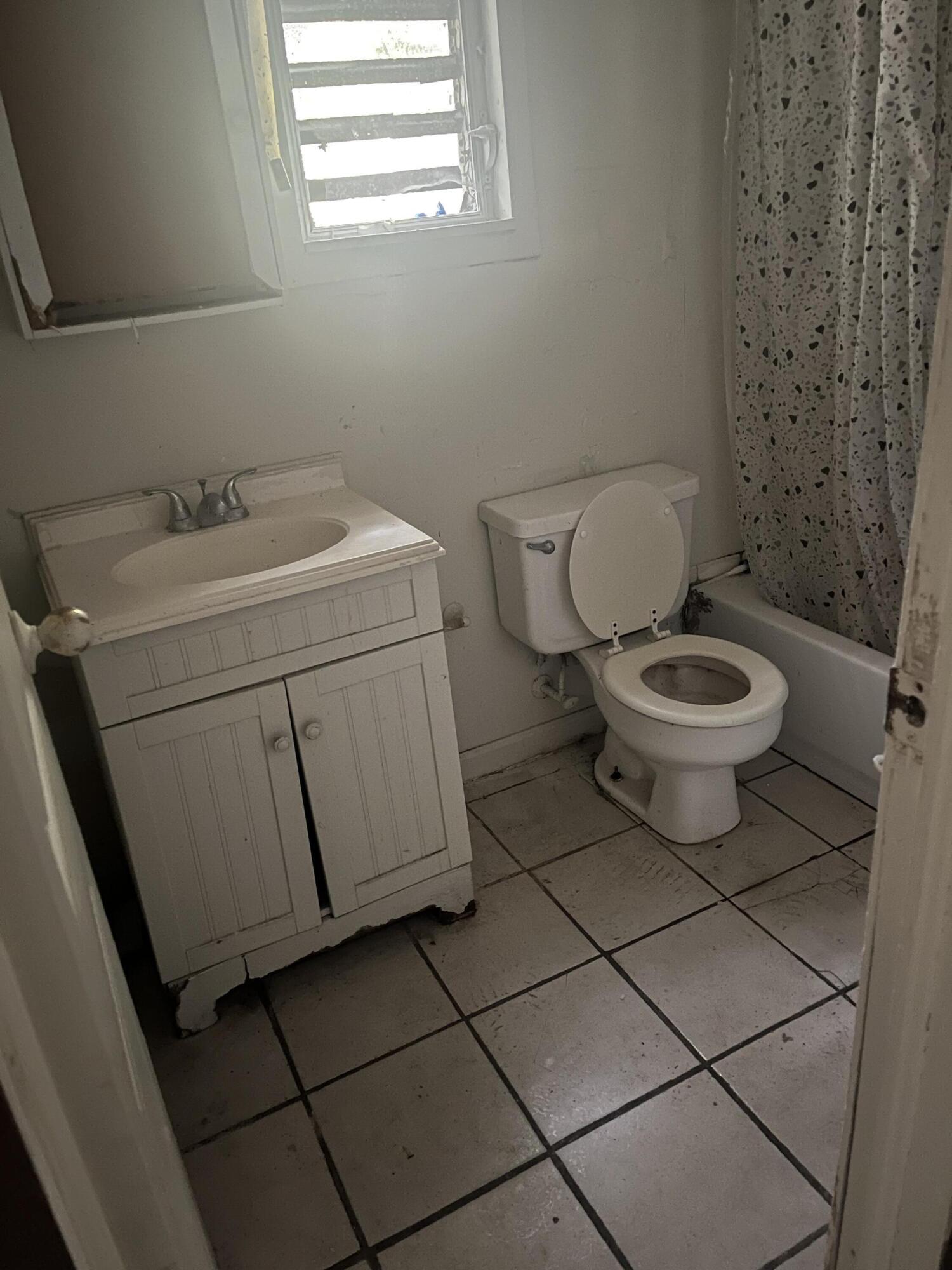 401-409 Brock Avenue Crestview, FL 32539 - Photo 5 of 10 a bathroom with a toilet and a sink