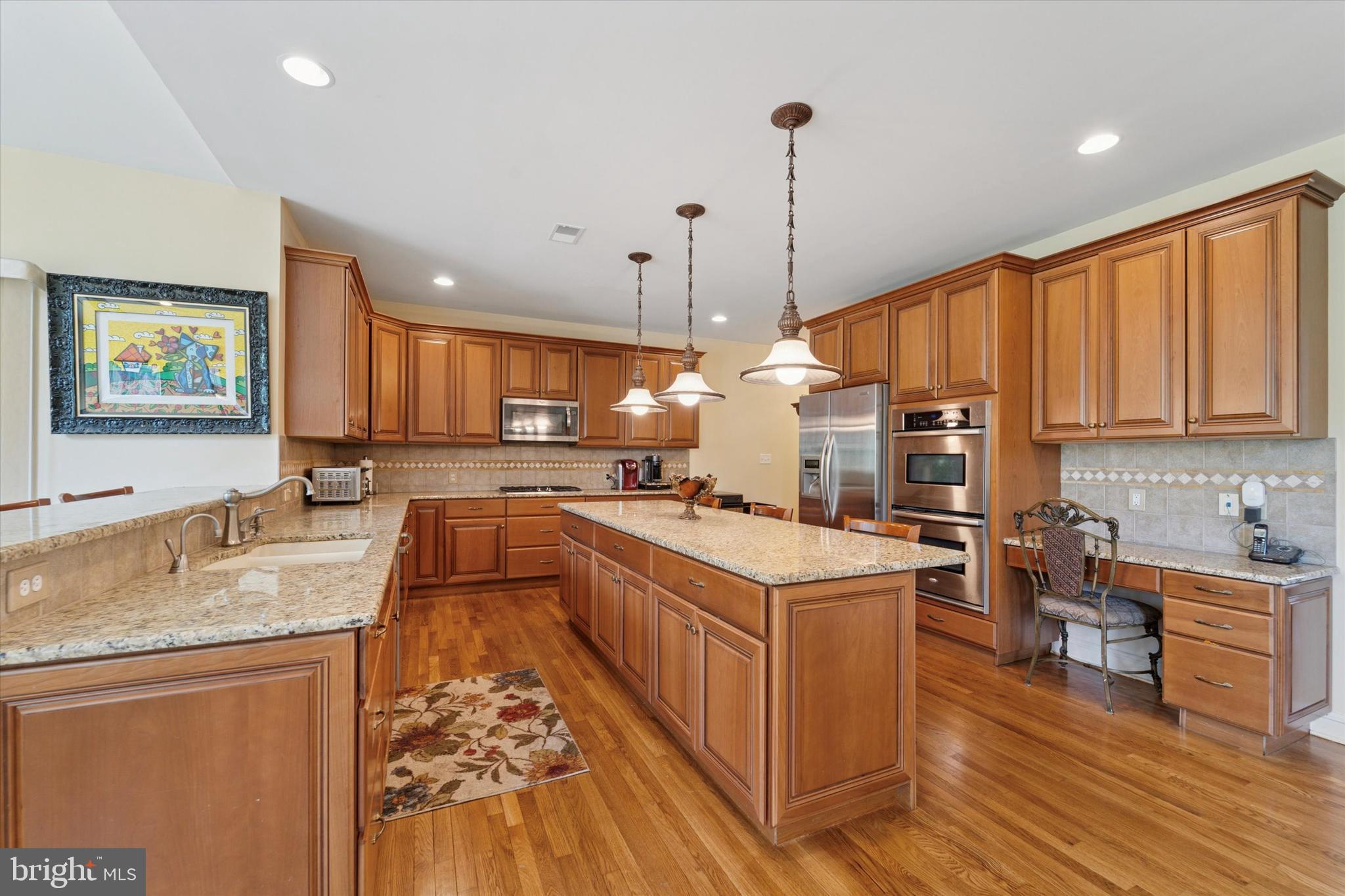 2001 Grenoble Road Coatesville, PA 19320 - Photo 12 of 45 a kitchen with stainless steel appliances granite countertop a sink a stove and a wooden floors