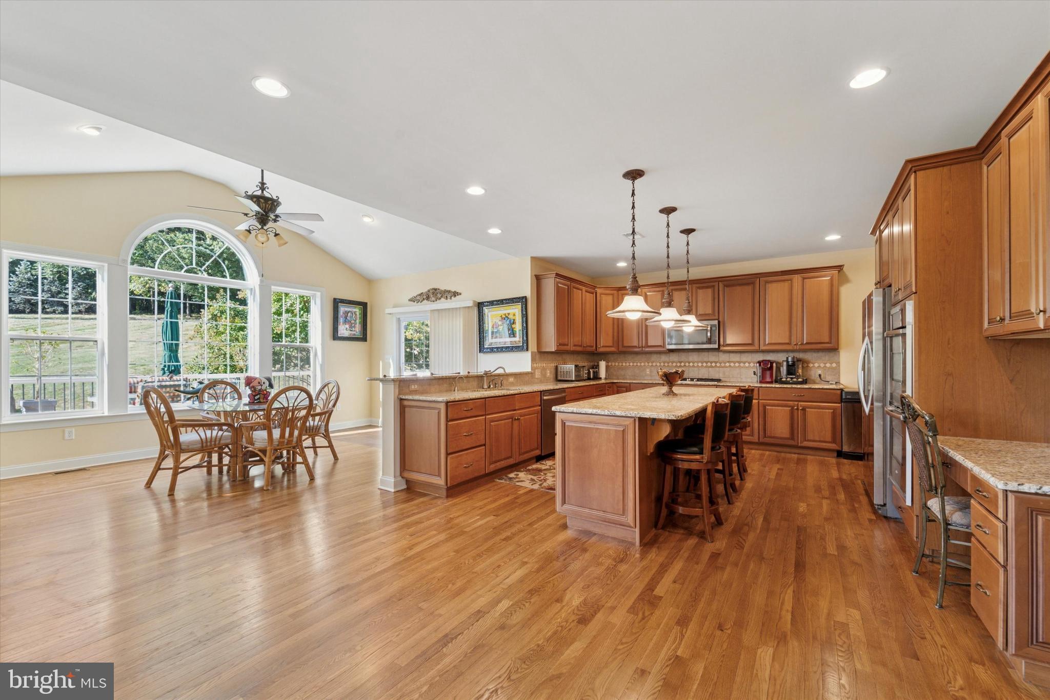 2001 Grenoble Road Coatesville, PA 19320 - Photo 13 of 45 a kitchen with stainless steel appliances granite countertop a table chairs stove and wooden floor