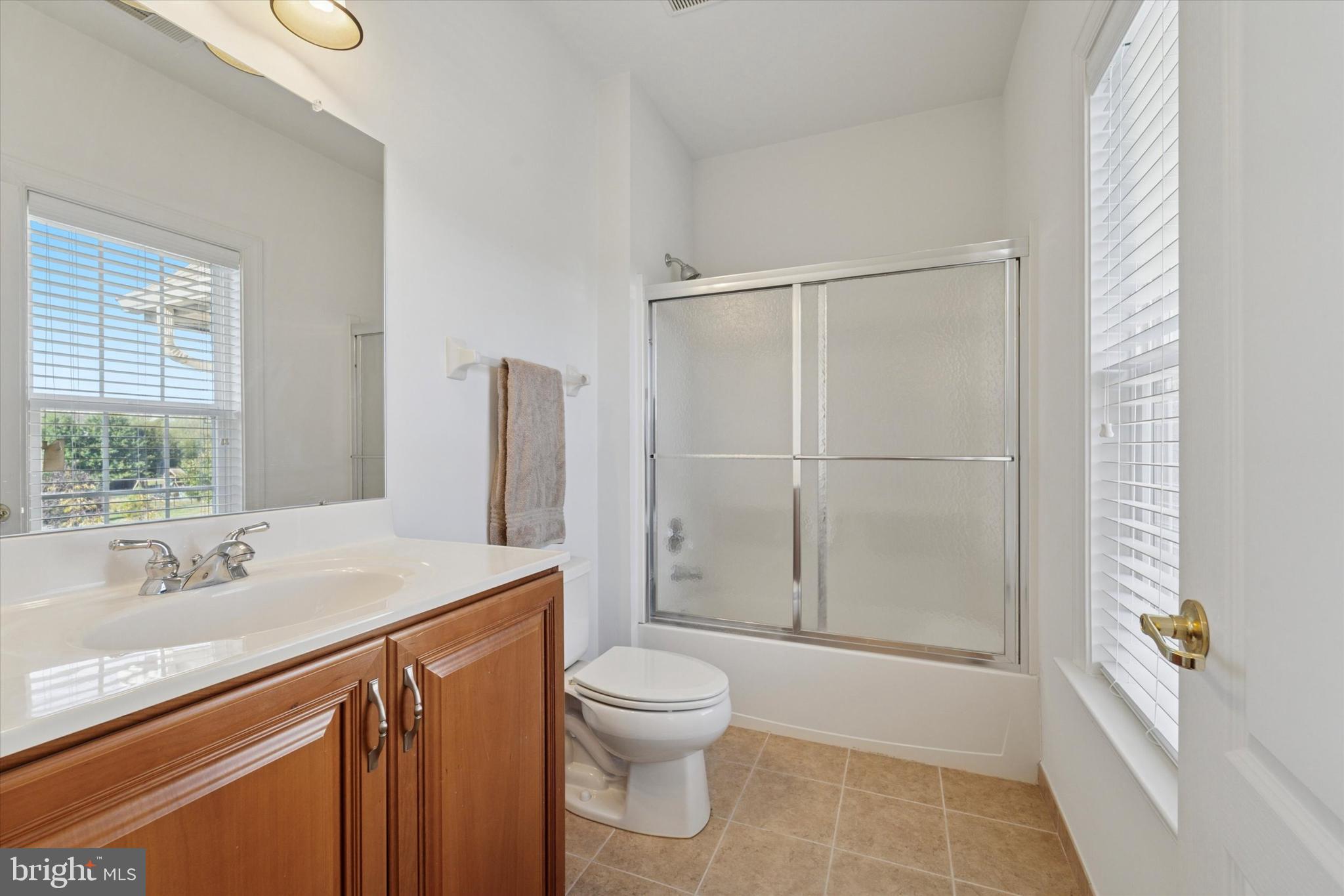 2001 Grenoble Road Coatesville, PA 19320 - Photo 23 of 45 a bathroom with a shower sink vanity mirror and toilet