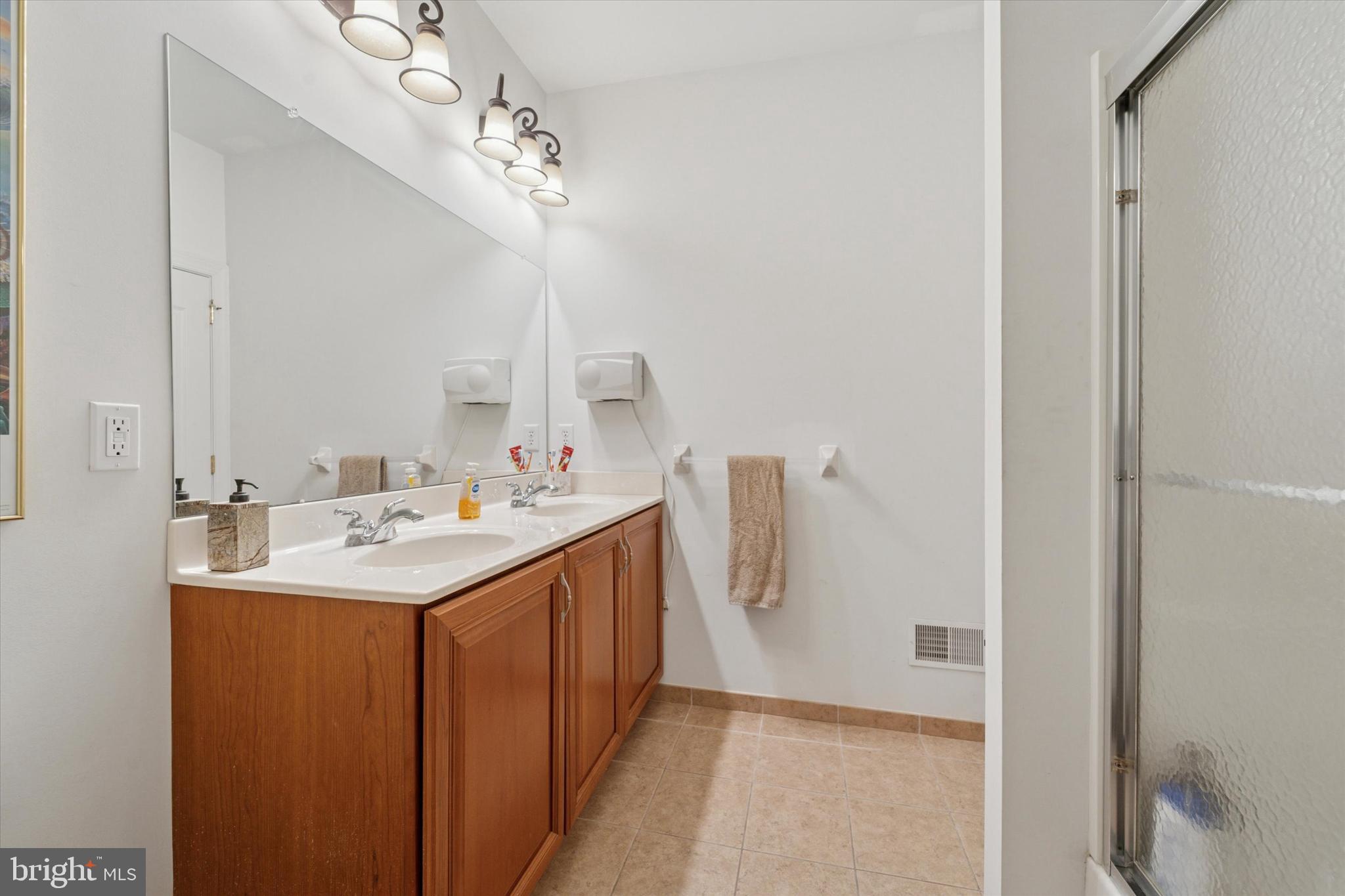 2001 Grenoble Road Coatesville, PA 19320 - Photo 25 of 45 a bathroom with a sink a mirror and a shower
