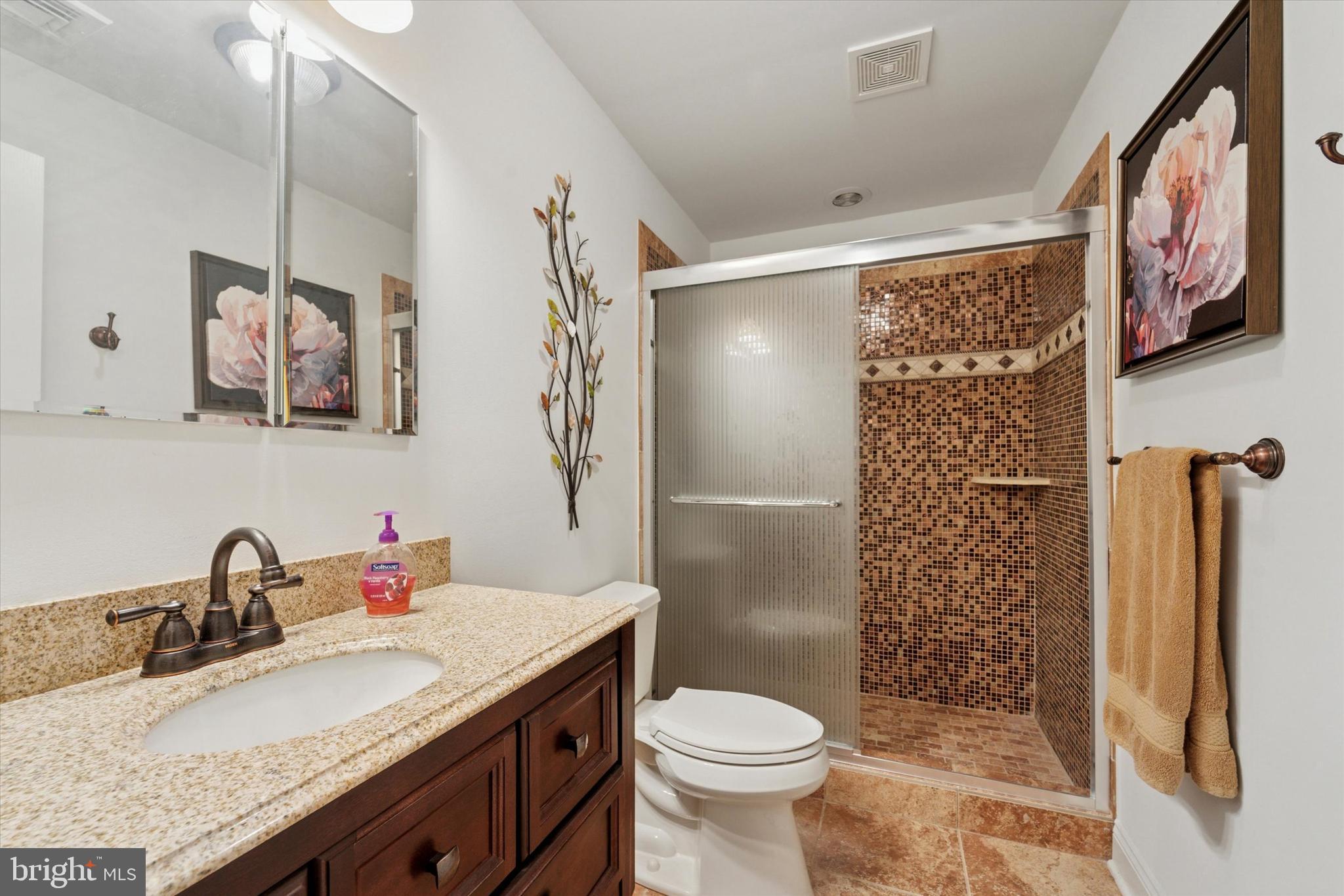 2001 Grenoble Road Coatesville, PA 19320 - Photo 35 of 45 a bathroom with a granite countertop sink toilet and shower