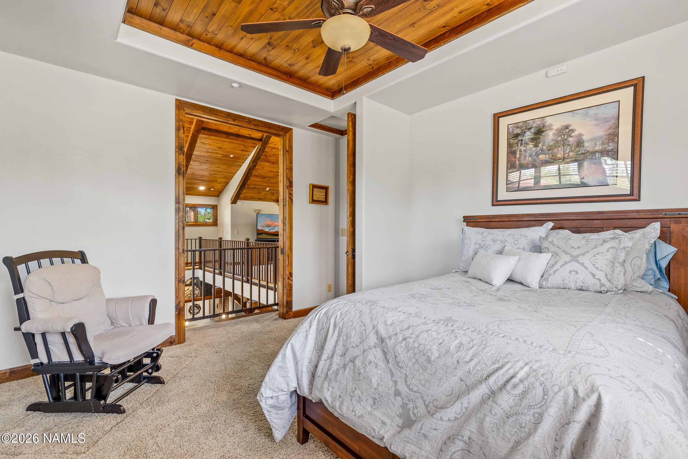 2214 East Del Rae Drive Flagstaff, AZ 86005 - Photo 28 of 45 a bed sitting in a spacious bedroom next to a window