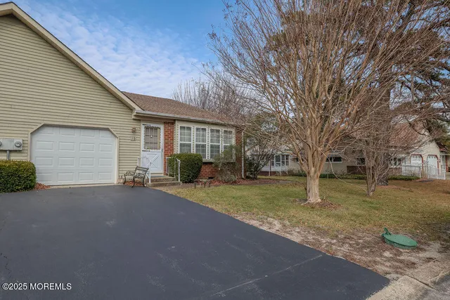 a view of a house with a yard and garage