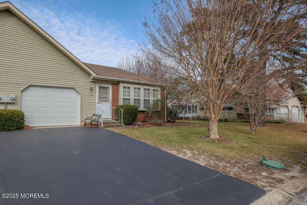 a view of a house with a yard and garage