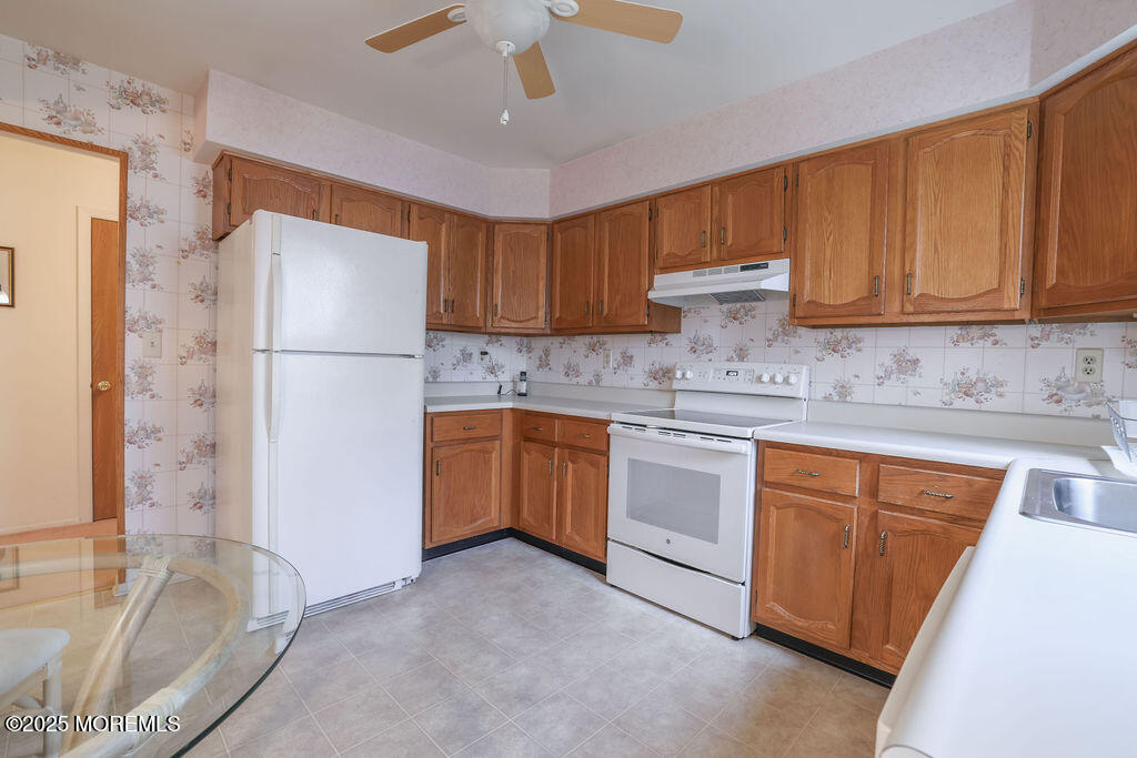 3 B Alpine Road, Unit 63 Whiting, NJ 08759 - Photo 12 of 26 a kitchen with a refrigerator sink and cabinets