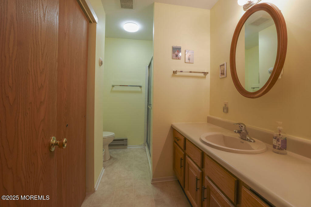 3 B Alpine Road, Unit 63 Whiting, NJ 08759 - Photo 22 of 26 a bathroom with a sink and a mirror