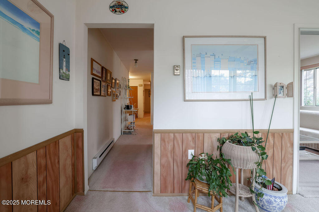 3 B Alpine Road, Unit 63 Whiting, NJ 08759 - Photo 4 of 26 a hallway with table and flowerpot