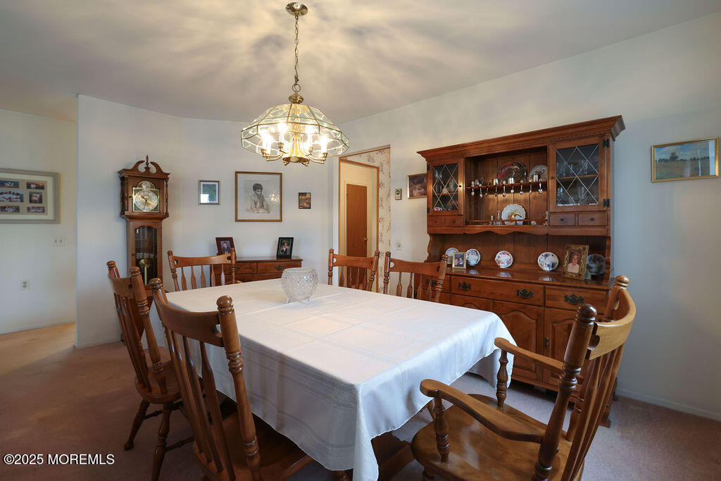 3 B Alpine Road, Unit 63 Whiting, NJ 08759 - Photo 9 of 26 a view of a dining room with furniture and chandelier