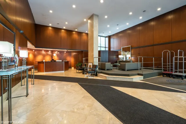 a lobby with a table and chairs