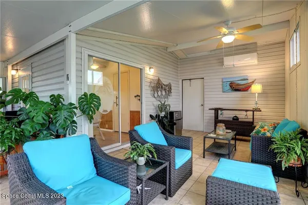 a living room with furniture and a potted plant