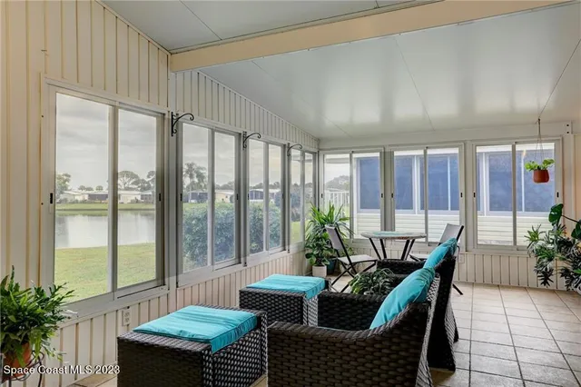 a living room with furniture and potted plants