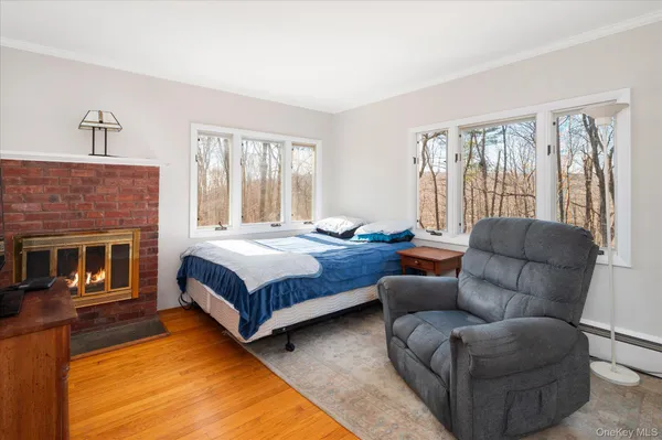 a bedroom with a bed couch and a large window