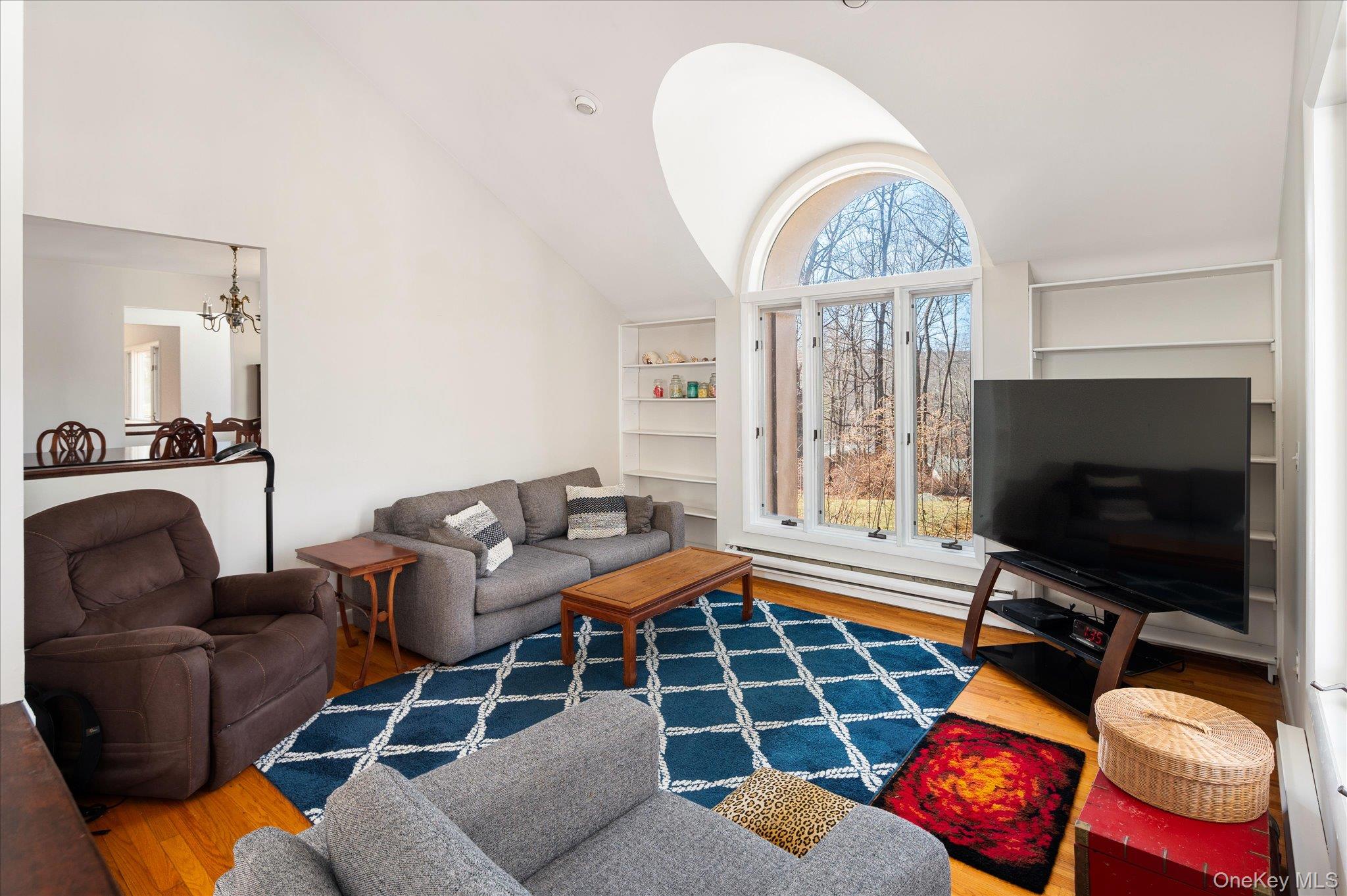 17 Highview Road Pound Ridge, NY 10576 - Photo 2 of 23 a living room with furniture a flat screen tv and large window