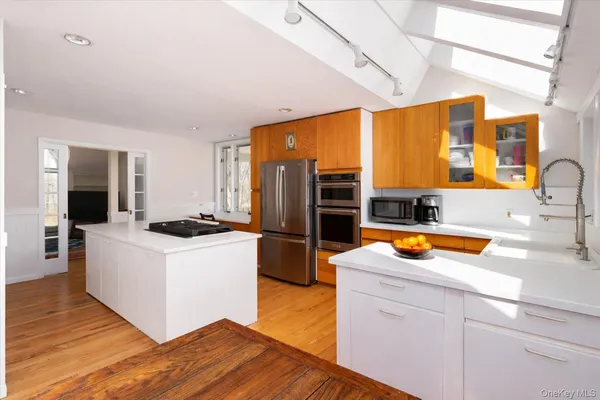 a kitchen with stainless steel appliances a sink and a refrigerator