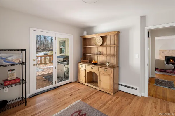 a kitchen with white cabinets and wooden floor
