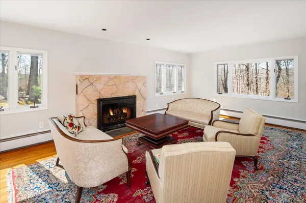 a living room with furniture fireplace and window