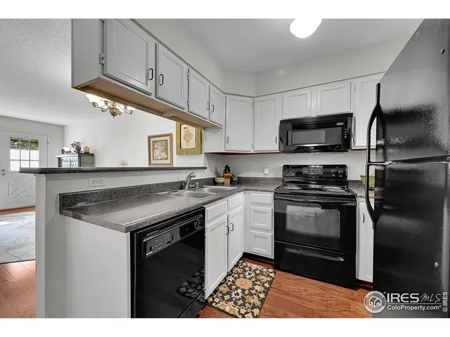 a kitchen with a refrigerator and a stove